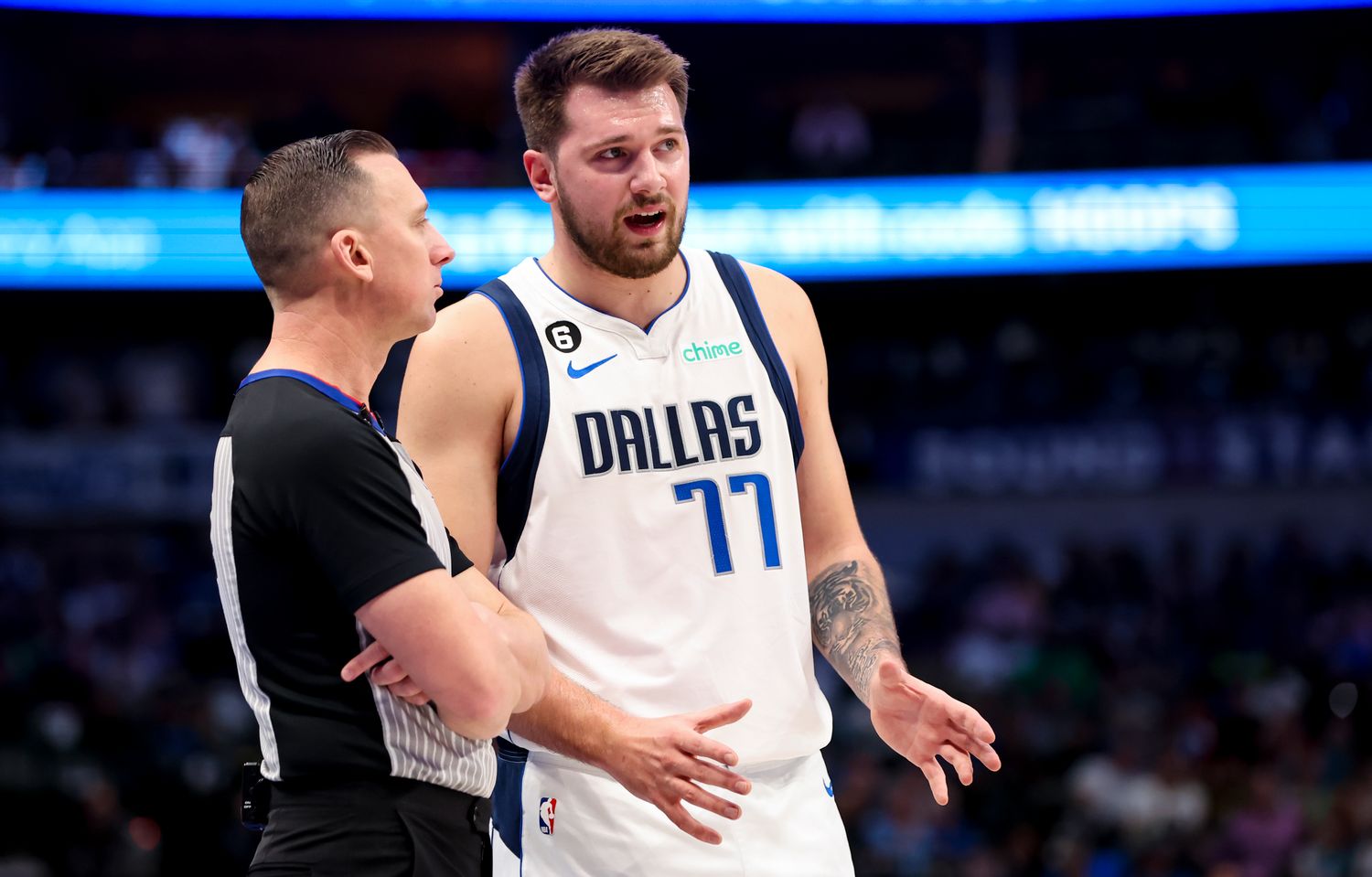 Mavericks guard Luka Doncic speaks with a referee.